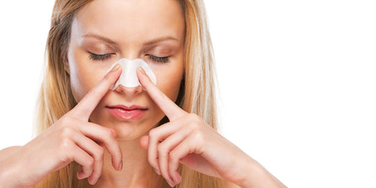 Woman Using Pore Strip On Nose