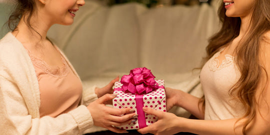 Woman Giving Friend A Gift